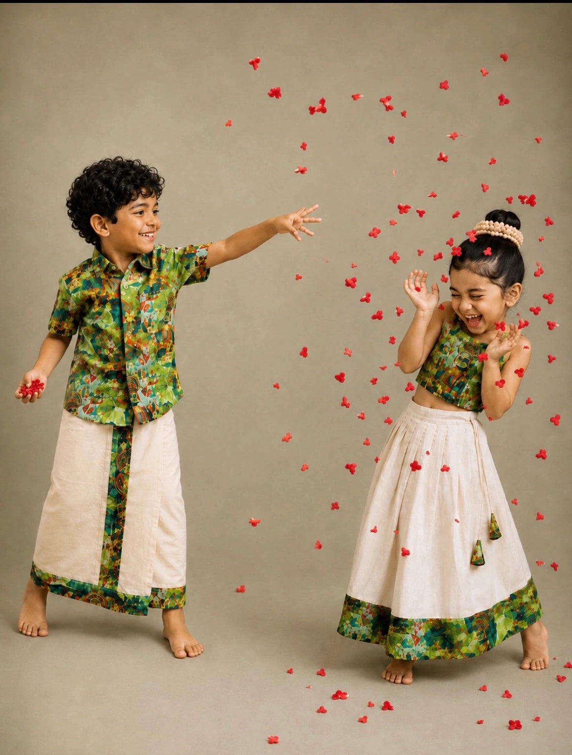 A boy and a girl in Nuts festive outfits playing among scattered petals